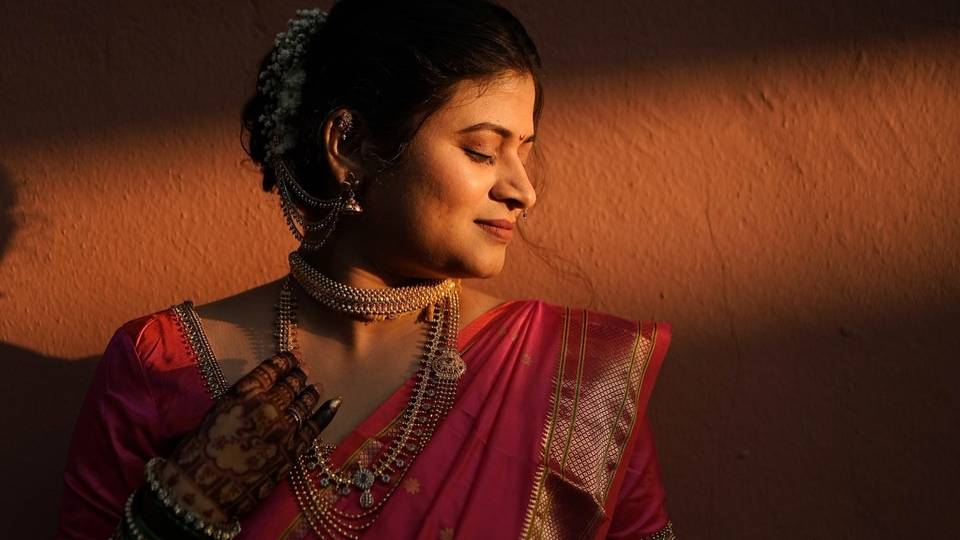 Bridal portrait in warm light, red saree